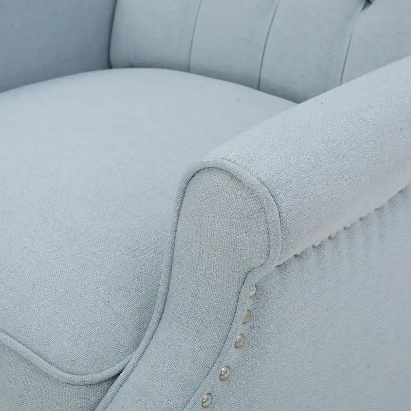Fauteuil de salon à oreilles en tissu capitonné