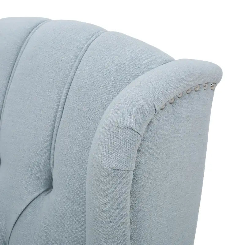 Fauteuil de salon à oreilles en tissu capitonné