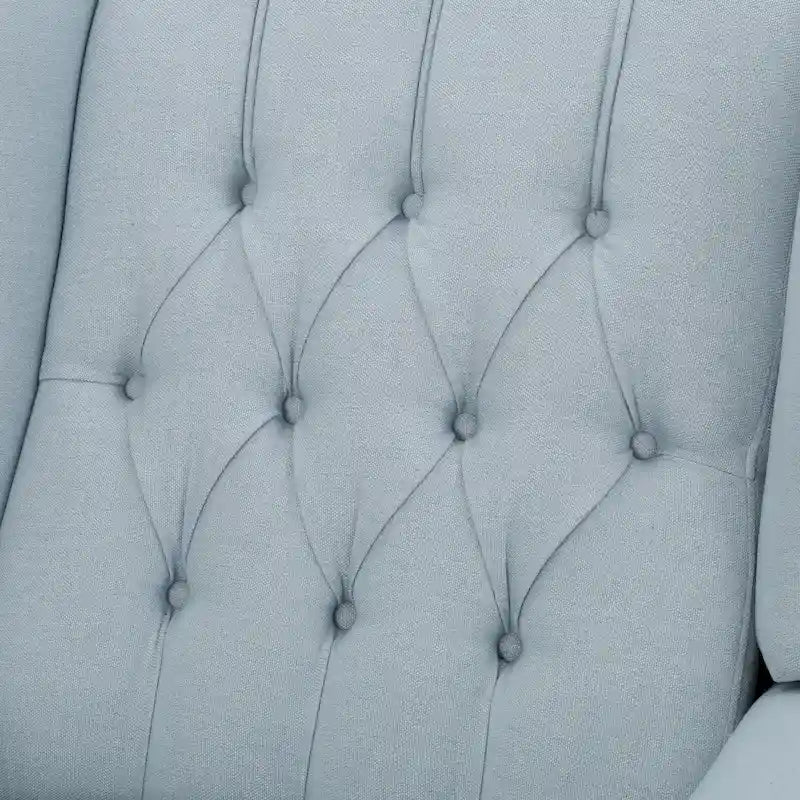 Fauteuil de salon à oreilles en tissu capitonné