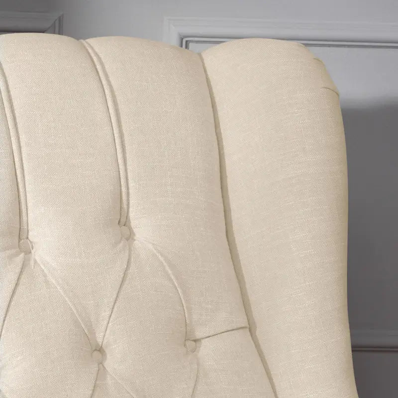 Fauteuil de salon à oreilles en tissu capitonné